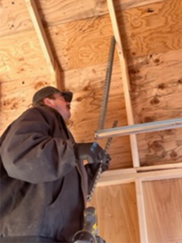 contractor installing new garage door at property wasilla ak